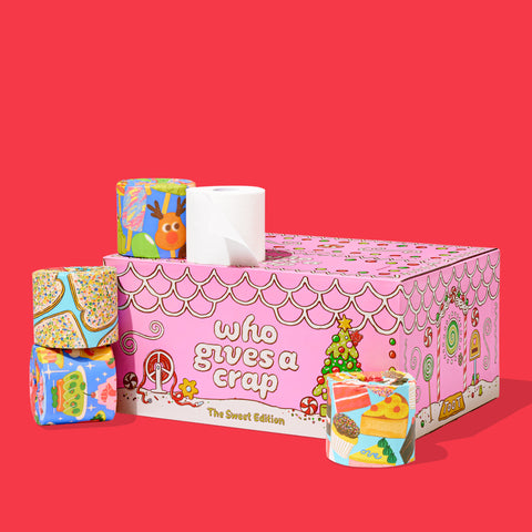 Colourful 'Who Gives a Crap' Sweet Limited Edition box decorated with candy illustrations, with toilet paper rolls stacked on top.