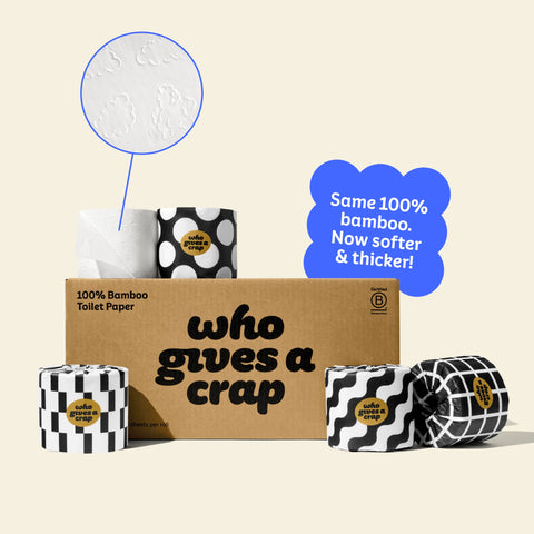 A medium box of Who Gives A Crap 100% Bamboo Toilet Paper with black and white wrappers - eco-friendly, biodegradable and sustainable toilet paper