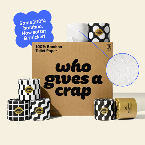 A large box of Who Gives A Crap 100% Bamboo Toilet Paper with black and white wrappers - eco-friendly, biodegradable and sustainable toilet paper